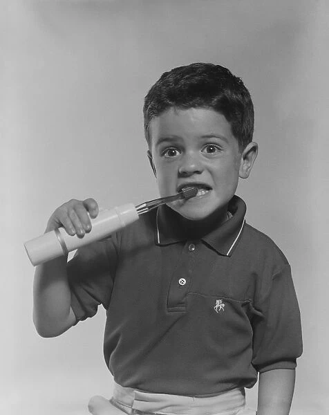Boy brushing teeth, portrait
