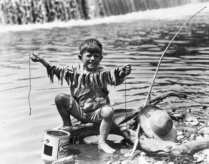 Framed Print : Boy Displays String Of Caught Fish
