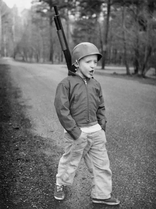 Framed Print : Boy Dressed in Military Wear and Mimicking a Soldier