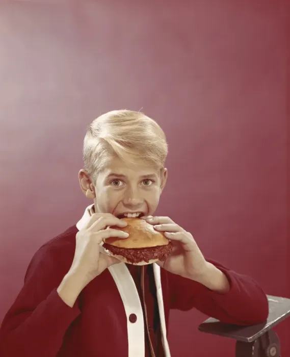 Framed Print : Boy eating burger, portrait Framed Print : Boy eating burger, portrait