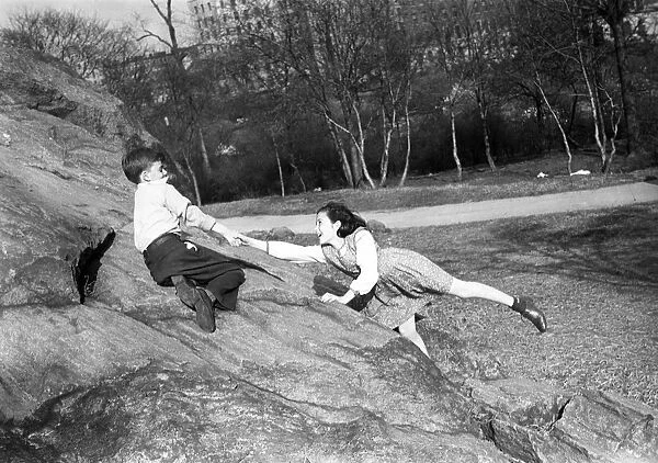 Boy and girl (10-11) playing in park