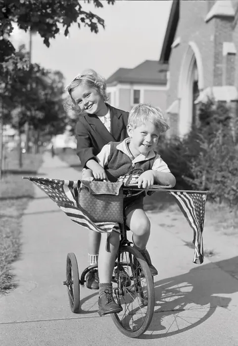 Framed Print : Boy and girl (8-9 years) riding bicycle, smiling. Phipps Garden apartment, Sunnyside, New York State, USA. September 08, 1938 Framed Print : Boy and girl (8-9 years) riding bicycle, smiling. Phipps Garden apartment, Sunnyside, New York State, USA. September 08, 1938