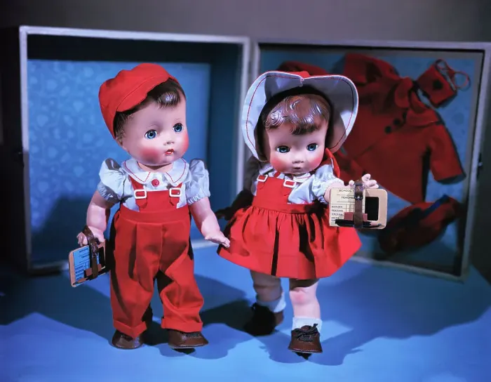 Framed Print : Boy and Girl Dolls Wearing Matching School Outfits