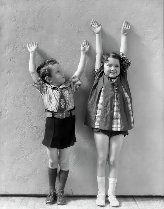 Framed Print : Boy & Girl Standing Next To One Another With Arms Raised Above There Heads Girl Is Wearing A Panel Dress And White Socks & Shoes Boy Shirt Tie Shorts Framed Print : Boy & Girl Standing Next To One Another With Arms Raised Above There Heads Girl Is Wearing A Panel Dress And White Socks & Shoes Boy Shirt Tie Shorts