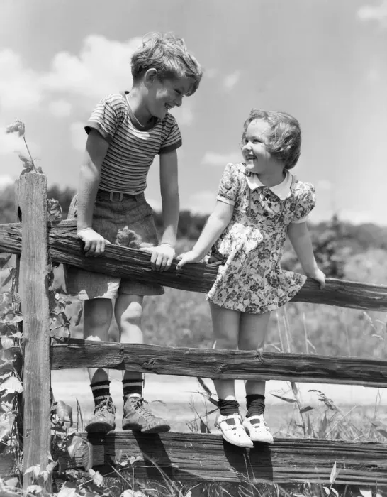 Framed Print : Boy and girl standing on split rail fence, looking at each other Framed Print : Boy and girl standing on split rail fence, looking at each other