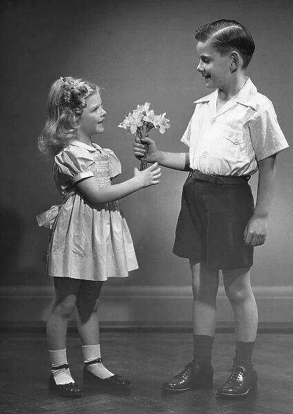 Boy giving flowers to girl