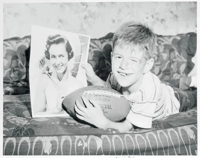 Framed Print : Boy Holding Football and Photo of Debbie Reynolds