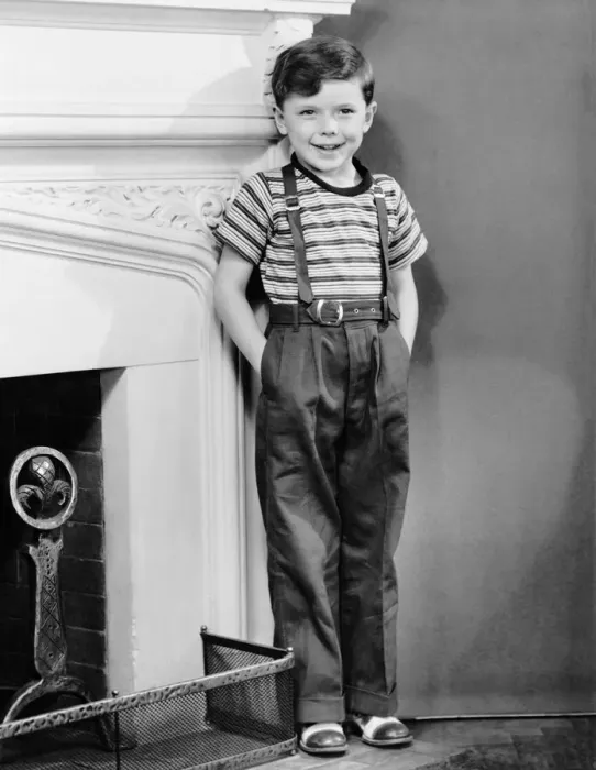 Framed Print : Boy leaning against wall by fireplace Framed Print : Boy leaning against wall by fireplace