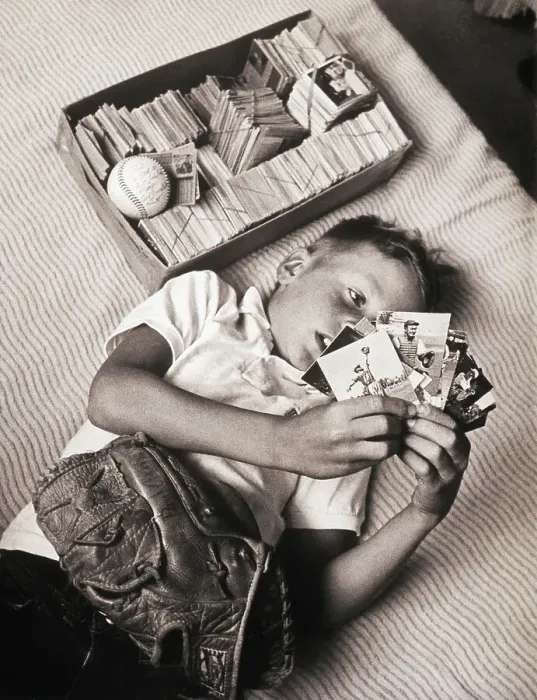 Framed Print : Boy Lying on Bed Studying Baseball Cards Framed Print : Boy Lying on Bed Studying Baseball Cards