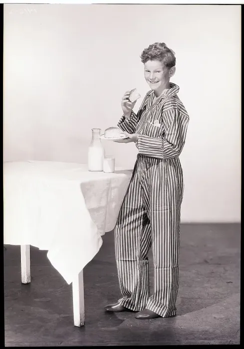 Framed Print : Boy in Pajamas Eating Cake and Milk Framed Print : Boy in Pajamas Eating Cake and Milk