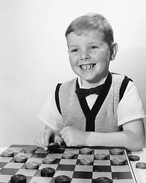 Boy playing checkers