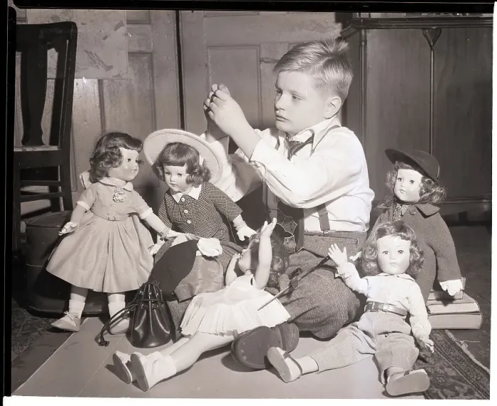 Framed Print : Boy Playing with Designer Dressed Dolls Framed Print : Boy Playing with Designer Dressed Dolls