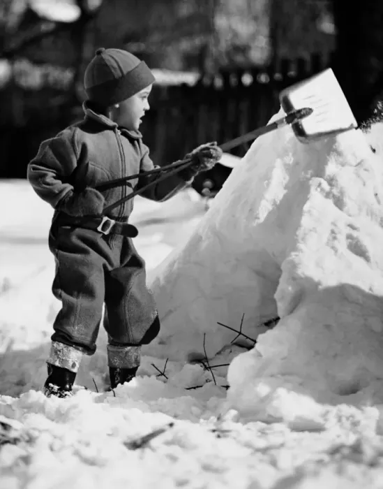 Framed Print : Boy playing with a shovel in the snow Framed Print : Boy playing with a shovel in the snow