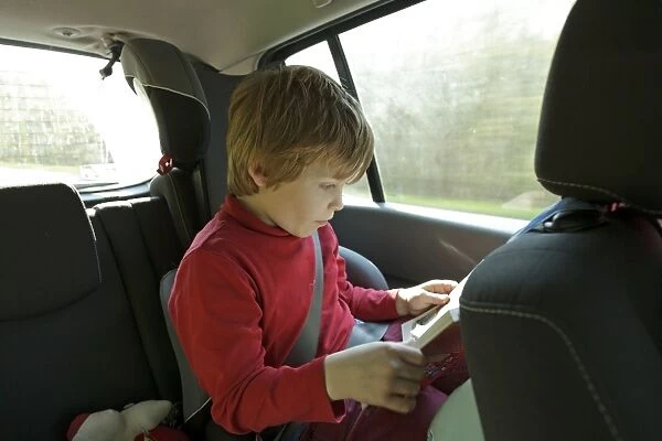 Boy reading in the car