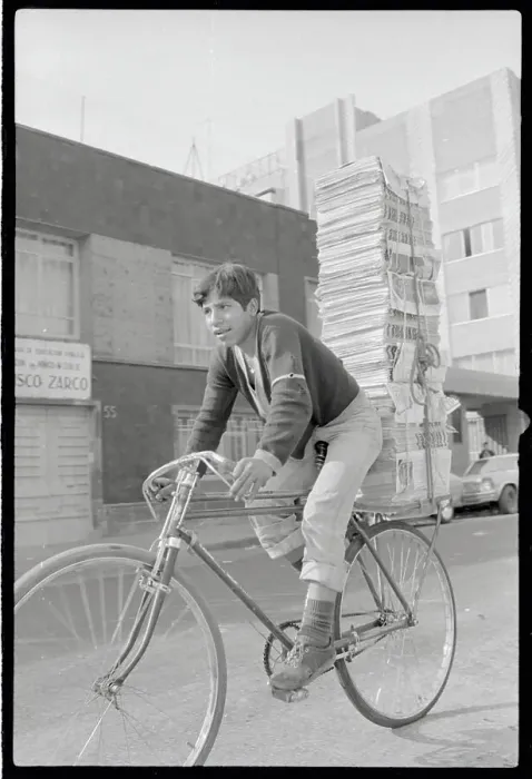 Framed Print : Boy Riding Bicycle with Tall Stack of Newspapers Framed Print : Boy Riding Bicycle with Tall Stack of Newspapers