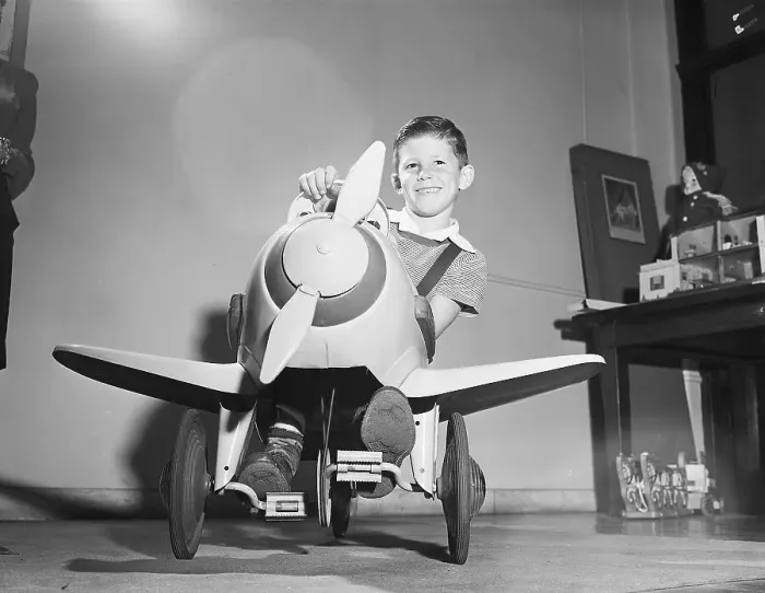 Framed Print : Boy Riding Plane Shaped Tricycle Framed Print : Boy Riding Plane Shaped Tricycle