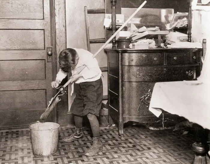 Framed Print : Boy Ringing Out a Mop