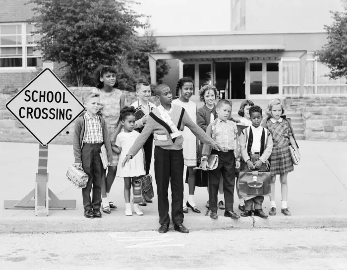 Framed Print : Boy safety guard with students at school crossing curb Framed Print : Boy safety guard with students at school crossing curb