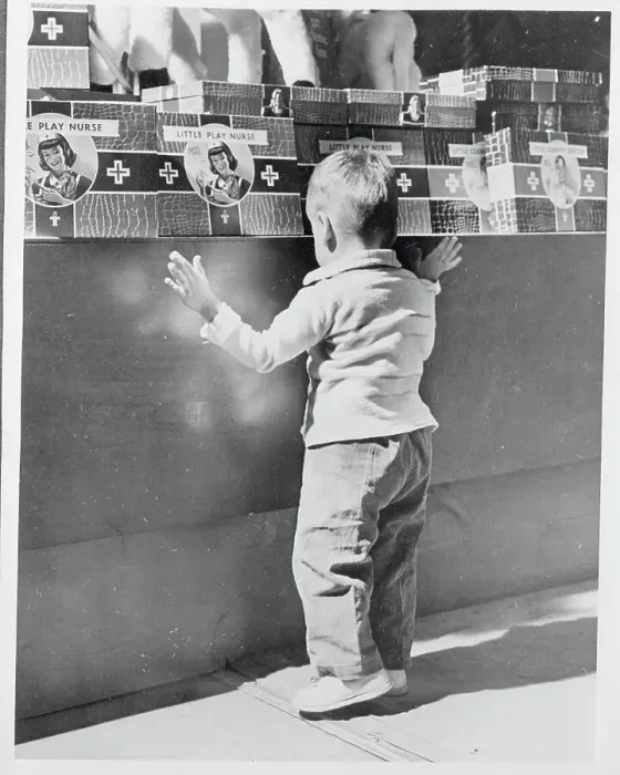 Framed Print : Boy Searching a Toy Counter Framed Print : Boy Searching a Toy Counter