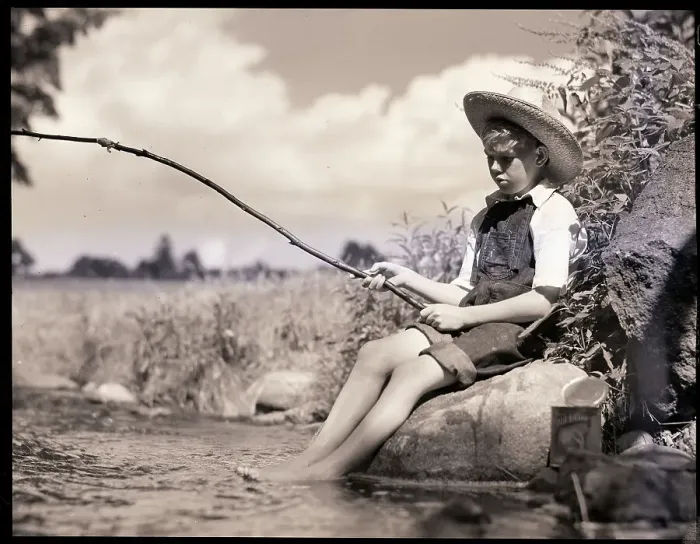 Framed Print : Boy Seated Fishing In Stream