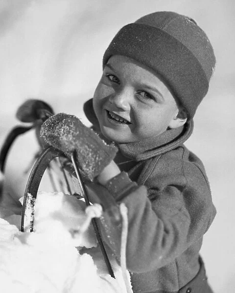 Boy with sled in snow