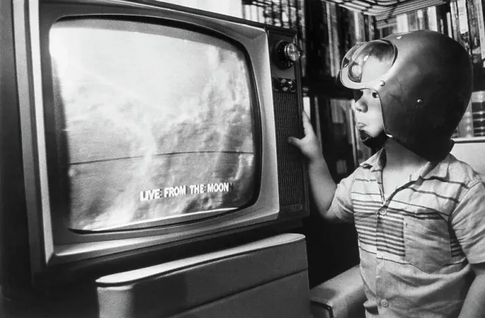 Framed Print : Boy with Space Helmet Watching Moon on Television Framed Print : Boy with Space Helmet Watching Moon on Television