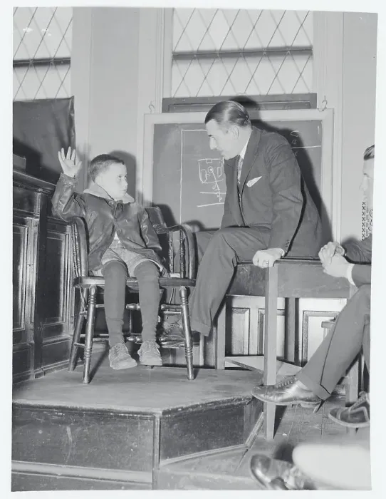 Framed Print : Boy Speaking to Coroner with Arm Raised Framed Print : Boy Speaking to Coroner with Arm Raised