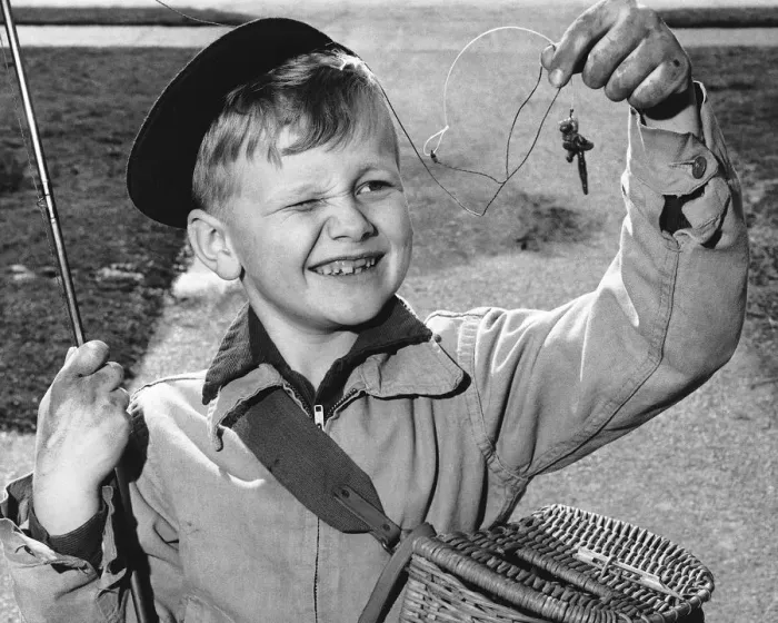 Framed Print : Boy squinting at baited hook Framed Print : Boy squinting at baited hook