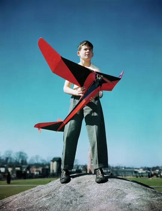 Framed Print : Boy Standing on Mound with Red Plane in His Hands Framed Print : Boy Standing on Mound with Red Plane in His Hands
