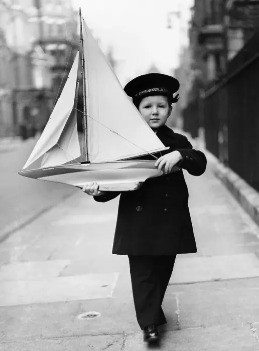 Framed Print : Boy with Toy Sailboat