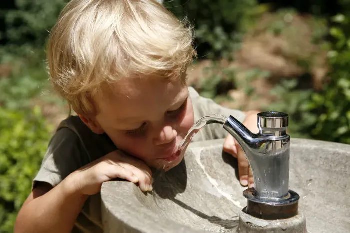 Framed Print : Boy, three years, drinking water from a public tap, Spain, Europe