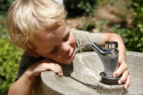 Boy, three years, drinking water from a public tap, Spain, Europe