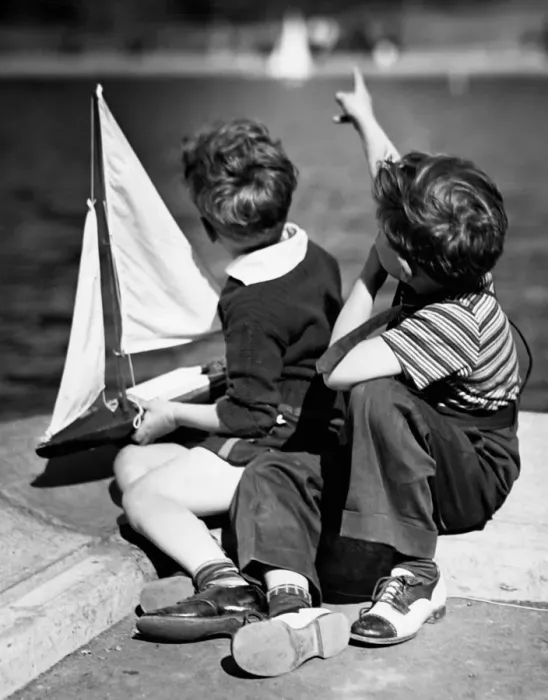 Framed Print : Two boys Playing with sailboats