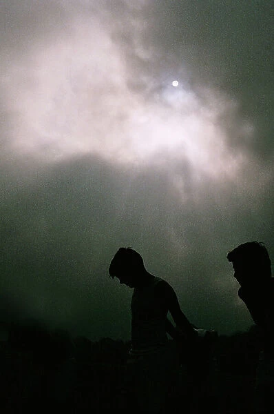 Boys Silhouette against Dramatic Sky