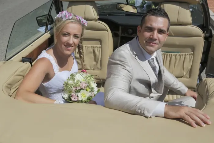 Framed Print : Bride and groom posing in the back seat of an open car, convertible Framed Print : Bride and groom posing in the back seat of an open car, convertible