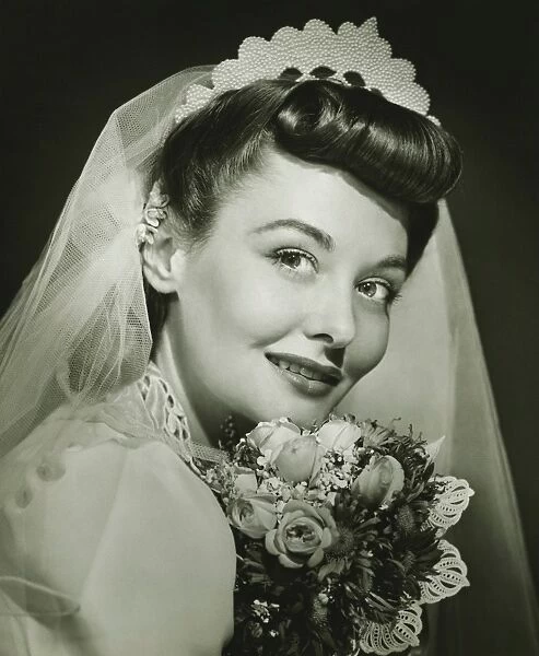 Bride posing in studio, (B&W), portrait