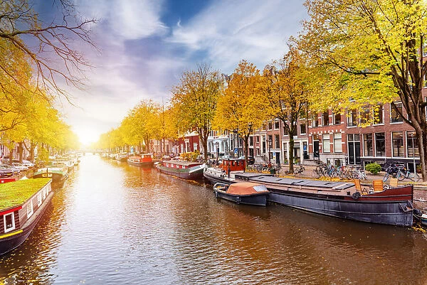 Bright sun in Herengracht canal in Amsterdam, Holland