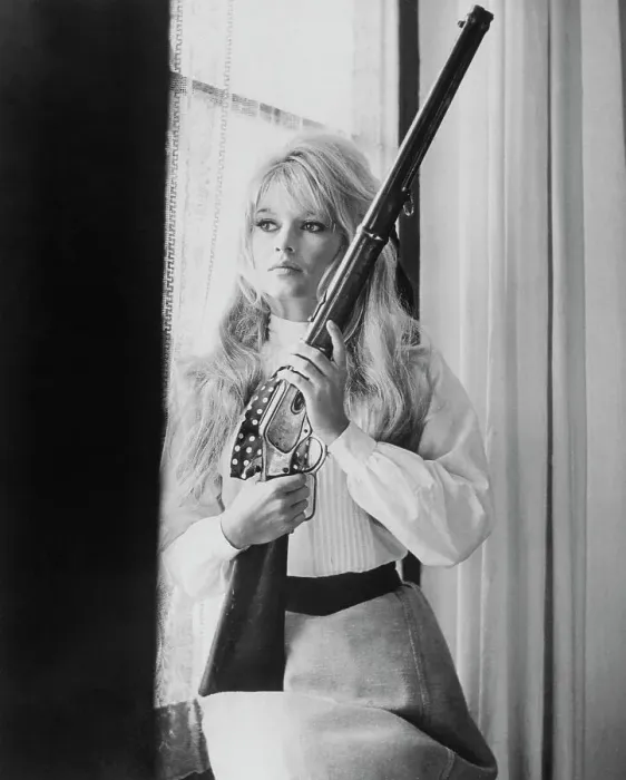 Framed Print : Brigitte Bardot Holding Gun Framed Print : Brigitte Bardot Holding Gun