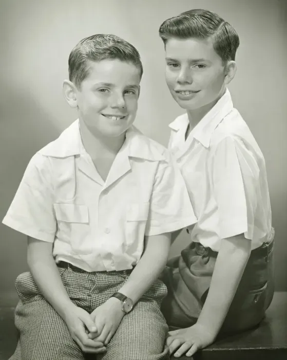 Framed Print : Brothers (8-9) (10-11) sitting in studio, smiling, (B&W), portrait Framed Print : Brothers (8-9) (10-11) sitting in studio, smiling, (B&W), portrait