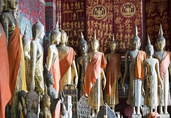 Buddha statues inside Royal Funerary Carriage House at Wat Xieng Thong. Luang Parbang, Laos