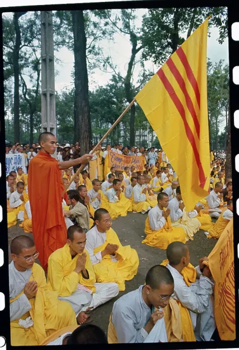 Framed Print : Buddhist Monk Holding a Flag Framed Print : Buddhist Monk Holding a Flag