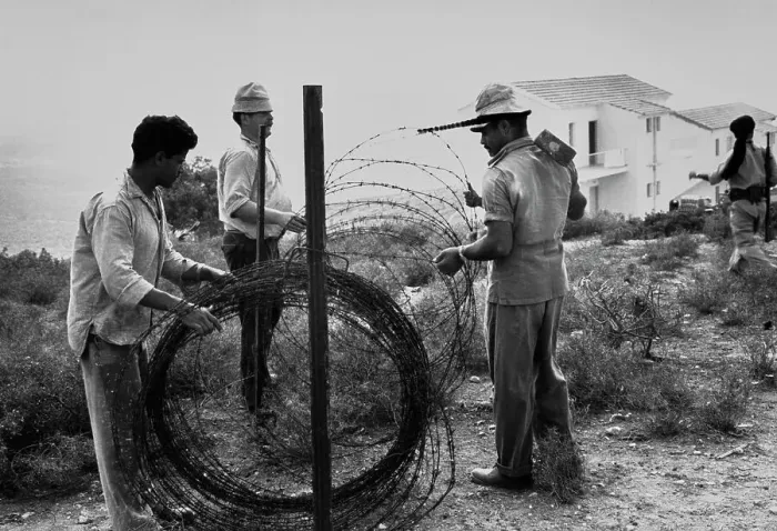 Framed Print : Building A Barbed Wire Fence