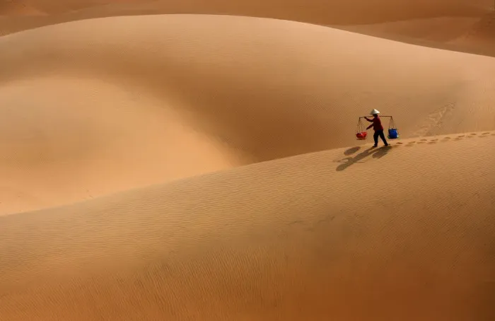 Framed Print : Burden Woman in Sand dune