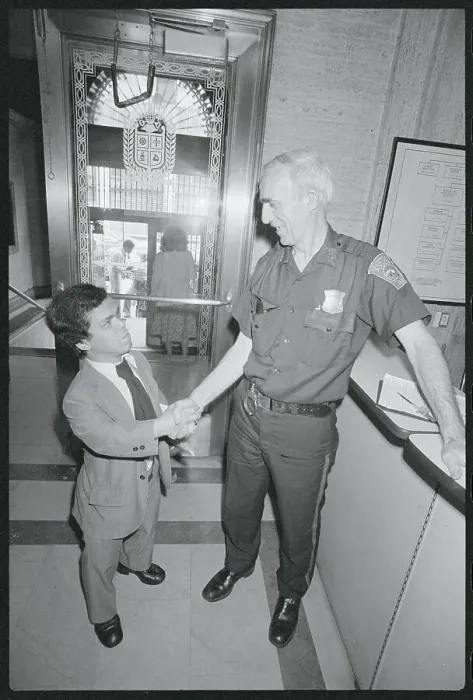 Framed Print : Burton Gutterman Shaking Hands with Police Officer Framed Print : Burton Gutterman Shaking Hands with Police Officer