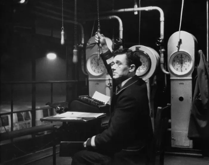 Framed Print : Bus Clerk. High up in the roof of a London Transport bus garage