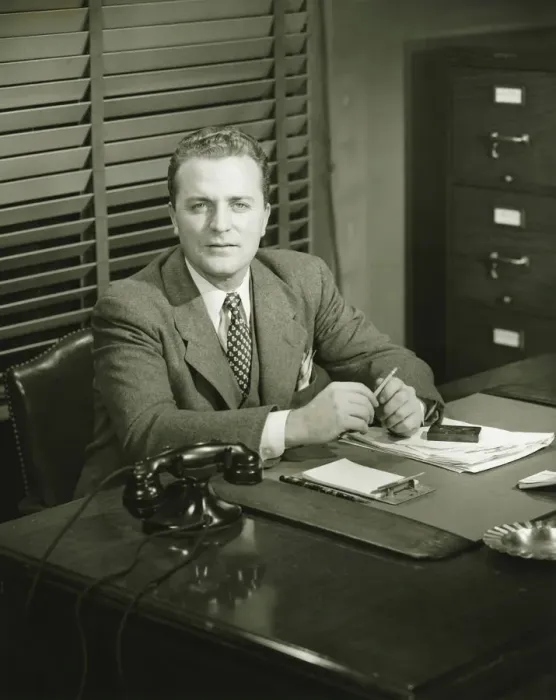Framed Print : Businessman holding pencil, sitting at office, (B&W) Framed Print : Businessman holding pencil, sitting at office, (B&W)