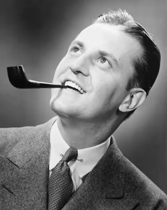Framed Print : Businessman holding pipe in teeth, (B&W), close-up Framed Print : Businessman holding pipe in teeth, (B&W), close-up
