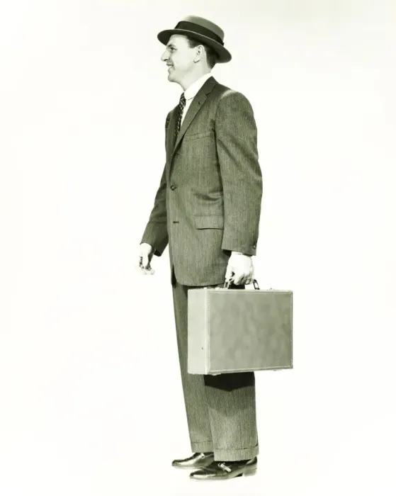Framed Print : Businessman standing in studio, holding briefcase, (B&W) Framed Print : Businessman standing in studio, holding briefcase, (B&W)
