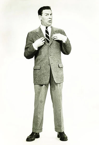 Businessman standing in studio, posing, (B&W)