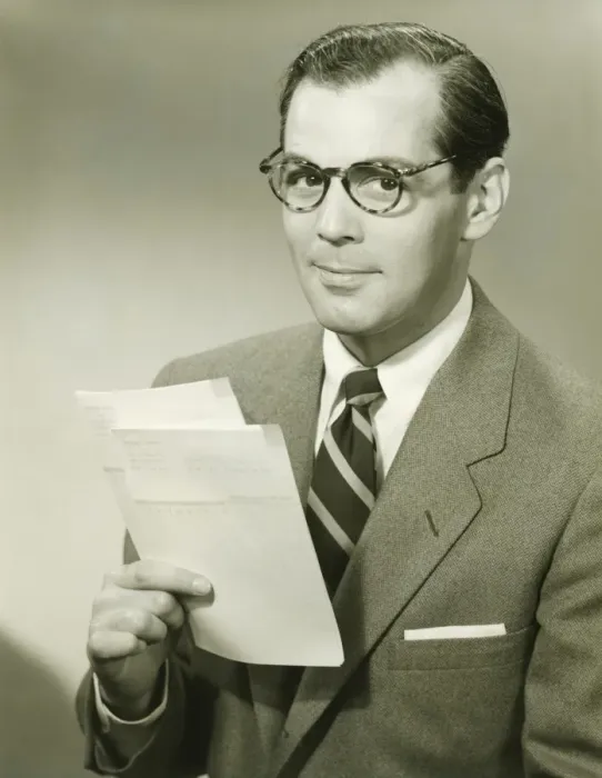 Framed Print : Businessman in studio holding papers, (B&W), portrait Framed Print : Businessman in studio holding papers, (B&W), portrait
